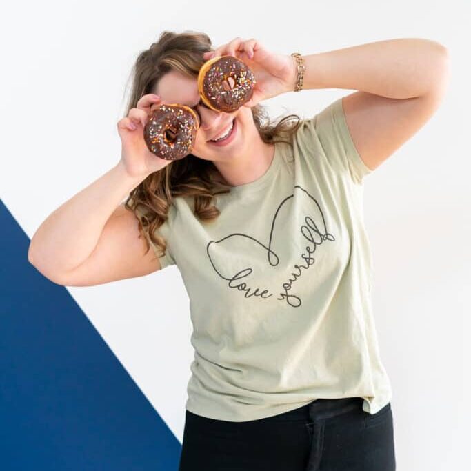 Nicole Ferri with donuts over her eyes; silly